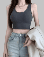 The person is paired with light blue high-waisted denim jeans.