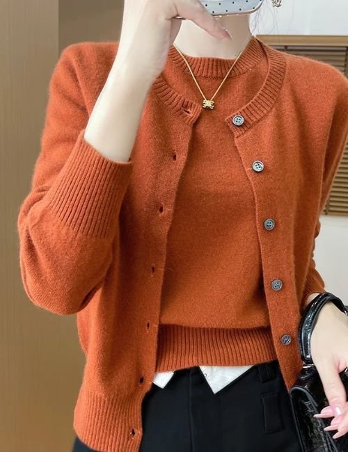 Woman wearing an orange two piece wool cardigan and short sleeve top set