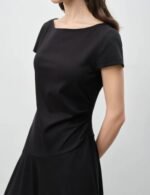Petite woman in draped midi dress