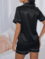 Back view of woman wearing satin pajama top and shorts set