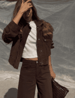 Woman wearing brown faux suede trucker jacket with jeans