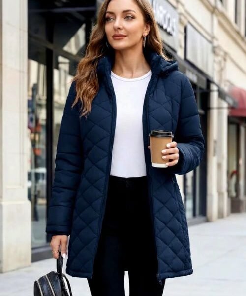 Womens puffer jacket in navy blue with hood, worn as a long winter coat